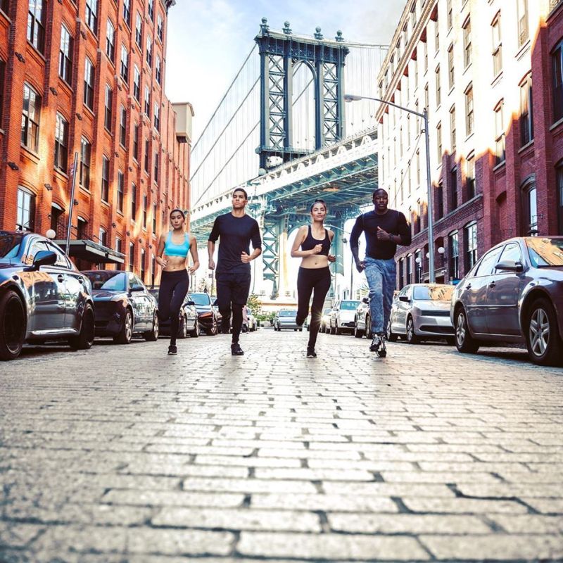 a group of people walking on a city street